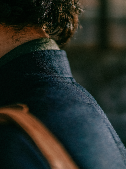 Close-up of the navy wool texture at the shoulder of the Tambo Jacket